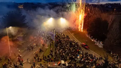 Ben Birchall/PA Wire Fireworks at vigil