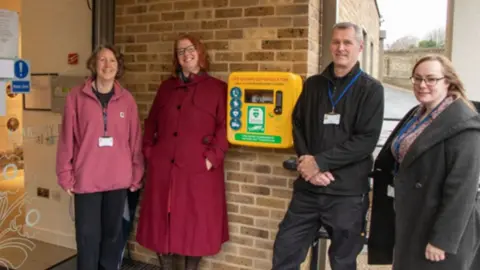 Dover District Council Charlotte Zosseder with Kearsney Parks staff and the new defibrillator