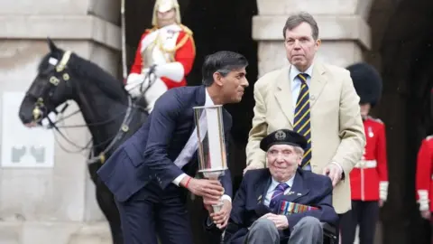 PA Media Prime Minister Rishi Sunak and D-Day veteran Peter Kent, 99