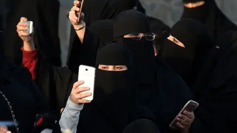 AFP/Getty Saudi women use their mobile phones during the Janadriyah festival of Heritage and Culture held in the Saudi village of Al-Thamama, 50 kilometres north of the capital Riyadh
