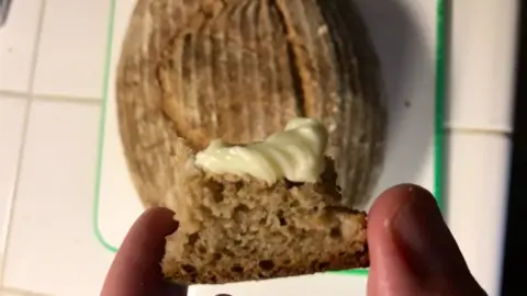 Maximilian Blackley Crust of risen loaf with butter on it