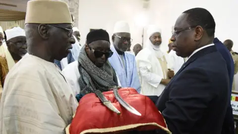 AFP Senegal President Macky Sall (R) receives the sword El Hadj Omar Tall during a ceremony with French Prime Minister Edouard Philippe at the Palace of the Republic in Dakar, Senegal, on November 17, 2019.