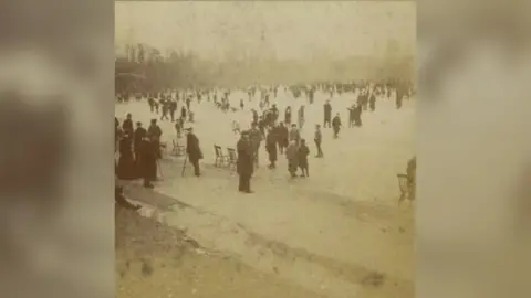 Museum of Liverpool People ice-skating on Sefton Park's frozen boating lake circa 1900