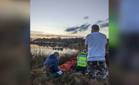 Aberdyfi Search and Rescue Team Photo of rescue teams helping the 73-year-old man with the sunset in the background