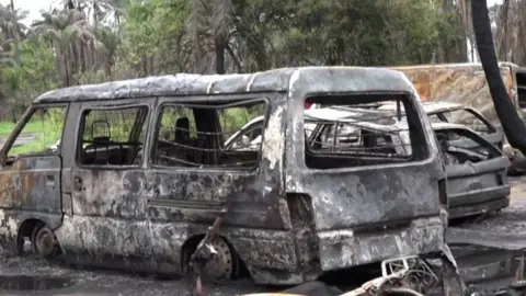 Reuters Burned-out vehicle