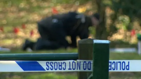 BBC Police on their knees searching the park