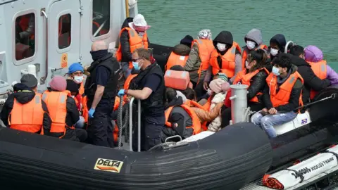 PA Media A group of people thought to be migrants are brought in to Dover, Kent, by Border Force earlier in May