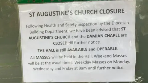 Martin Heath/BBC Notice on the front door of the church, advising parishioners that masses will be held in the church hall