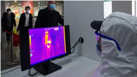 Getty Images A fever detection system in use at a train station in China