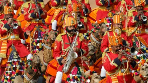 Reuters Indian Border Security Force (BSF) soldiers play music as they ride their camels during India's Republic Day parade in New Delhi, India, January, 26, 2020.