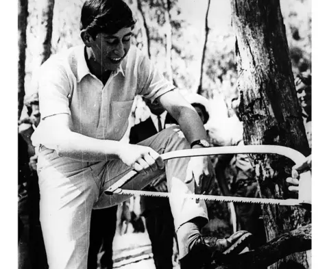 Getty Images King Charles uses a handsaw while a student at Timbertop