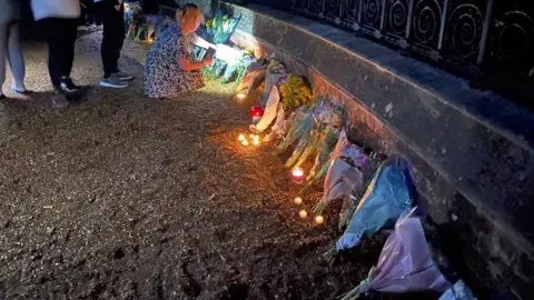 Candles and flower tributes at Sandringham gates