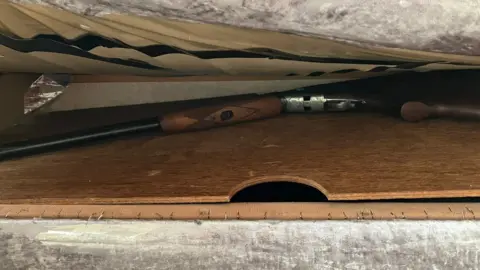 Gloucestershire Police  A shotgun hidden under a mattress