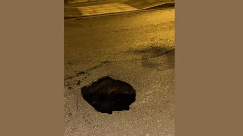 Lauren Holmes Sinkhole in the road