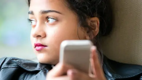 Getty Images Teenager on phone