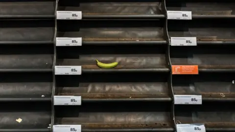 Getty Images The last banana left on the empty shelves for fruit in a Tesco supermarket on 18th May 2020 in London, United Kingdom. Supermarkets have been working around the clock to keep up with growing customer demands amid the coronavirus crisis. With many Britons rushing to stores to stockpile essential items, supermarkets across the nation have been forced to impose strict rules. (photo by Barry Lewis/In Pictures via Getty Images)