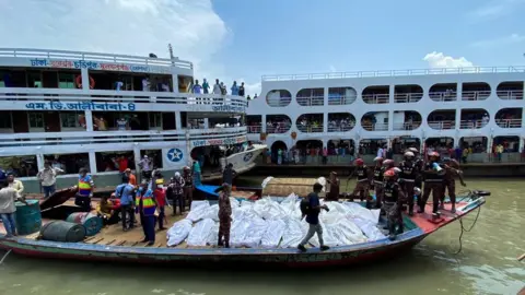 AFP Rescue workers bring bodies of victims after a ferry capsized at the Sadarghat ferry terminal in Dhaka on June 29, 2020.