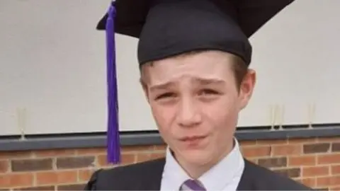 Family handout Robert Hattersley wears a graduation cap and gown at his school