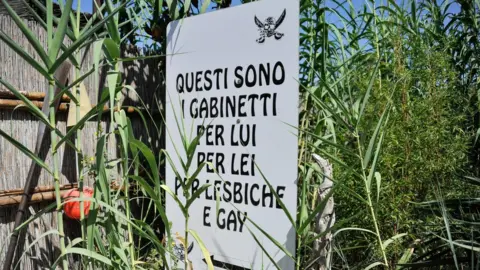 EPA A sign at the beach at Chioggia boasts of toilets "for him, for her, for lesbians and gays"