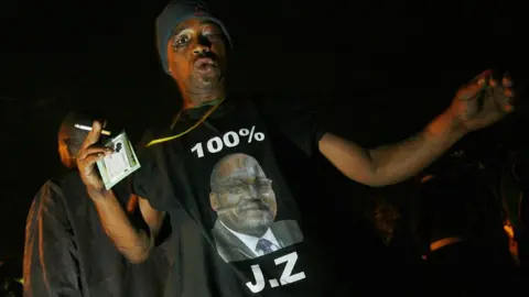 Getty Images South Africa's ruling party ANC president Jacob Zuma's supporters sing and dance on August 3, 2008 in front of the Pietermaritzburg High Court on the eve of a Court hearing on Zuma's corruption case