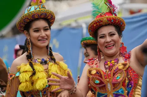 PA Media Bolivian cultural dancers wait to perform at London's New Year's Day concert in Waterloo Place, London