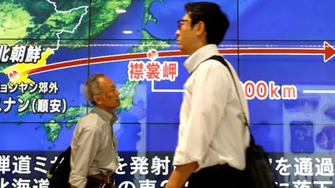 Reuters Passersby walk in front of a TV screen reporting news about North Korea"s missile launch, in Tokyo, Japan, September 15, 2017.