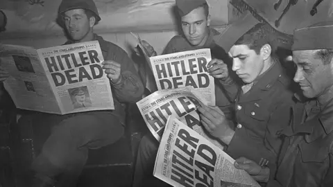 Getty Images US troops read about Adolf Hitler's death in Stars and Stripes