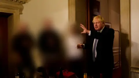 Sue Gray report/Cabinet Office/PA Boris Johnson holding glass of wine in Downing Street, others blurred out