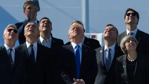 AFP King Philippe of Belgium, NATO Secretary General Jens Stoltenberg, Greek Prime Minister Alexis Tsipras, US President Donald Trump, Poland's President Andrzej Duda, Britain's Prime Minister Theresa May and Canada's Prime Minister Justin Trudeau watch planes flying during the handover ceremony of the new headquarters of NATO (North Atlantic Treaty Organization) in Brussels, on May 25, 2017.