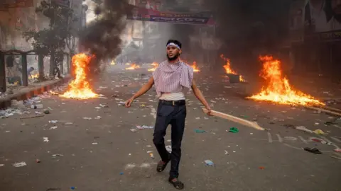 EPA A Bangladesh Nationalist Party supporter participates in a protest demanding the resignation of Prime Minister Sheikh Hasina in Dhaka