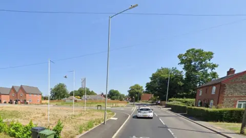 Google Undeveloped land where the pub used to be, and a road into a new housing development