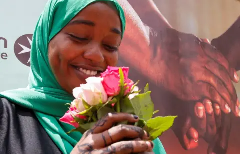 Reuters A woman smiles and holds a bunch of roses she received after donating blood during a Valentine's Day campaign with the theme "Show your love, by donating blood" in Nairobi, Kenya - Monday 14 February 2022