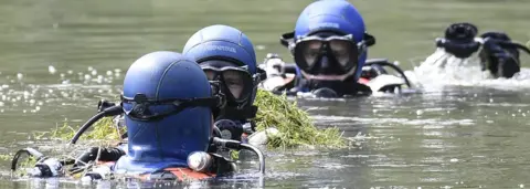 AFP Divers of the French gendarmerie search for evidence in a pond near Pont-de-Beauvoisin, eastern france, on August 30, 2017