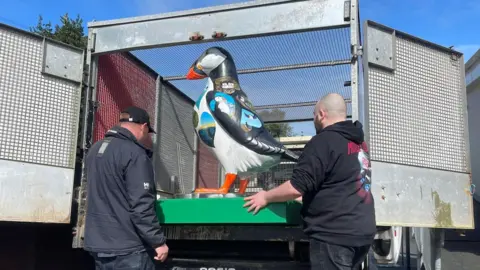 GSPCA Puffin statue in a van