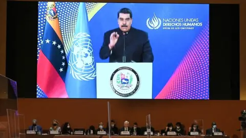 Reuters Venezuelan President Nicolás Maduro appears on a screen as he delivers a remote speech at the opening of a session of the UN Human Rights Council in Geneva, following Russia's invasion in Ukraine