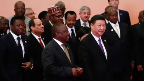 AFP China's President Xi Jinping walks infront of African leaders