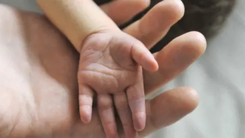 BBC Child and parent's hands