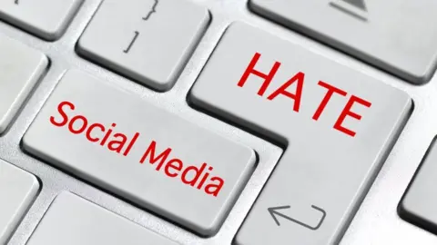 Getty Images Composite image of a keyboard with words hate and social media superimposed