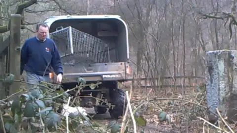 Hunt Investigation Team Christopher White moving the trap