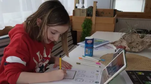 Naomi Bella doing a home-education activity