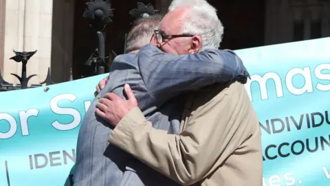 PA Media Cleared: Noel Thomas hugs a fellow postmaster outside Royal Courts of Justice in April 2021