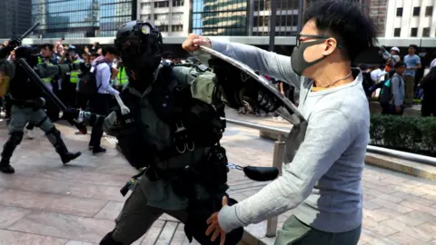 Wales News Service Riot police fighting with protester
