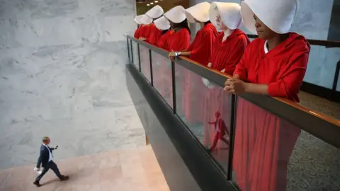 Getty Images A group of women are seen dressed as 'Handmaids' from the Hulu original series 'The Handmaid's Tale' in the Hart Senate Office Building hearing in response to Supreme Court nominee Brett Kavanaugh's hearing.