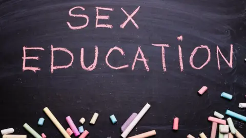 Alexmia/Getty Images Sex education written on a black chalkboard