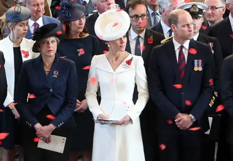 Andrew Matthews/ PA Wire Theresa May and The Duke and Duchess of Cambridge watch poppies fall
