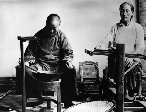 Getty Images Chinese workers spinning silk, circa 1912