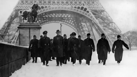 Getty Images German Soldiers Cross The Iena Bridge, Covered In Snow, In Front Of The Eiffel Tower In Paris in January 1941