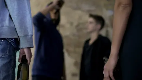 Getty Images A teenager drinking from a bottle