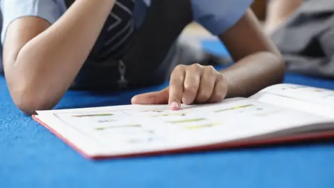 School girl reading book