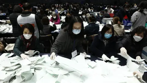 Getty Images Officials from the South Korean Central Election Management Committee and election observers count votes